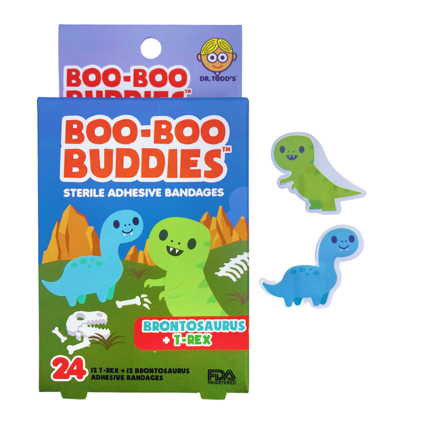 A colorful box of Boo-Boo Buddies bandages featuring two cute dinosaur shapes: a smiling green T-Rex and a blue Brontosaurus. The packaging shows a fun prehistoric scene with orange mountains and a dinosaur skeleton. The box contains 24 bandages (12 of each design) and emphasizes that they are sterile
